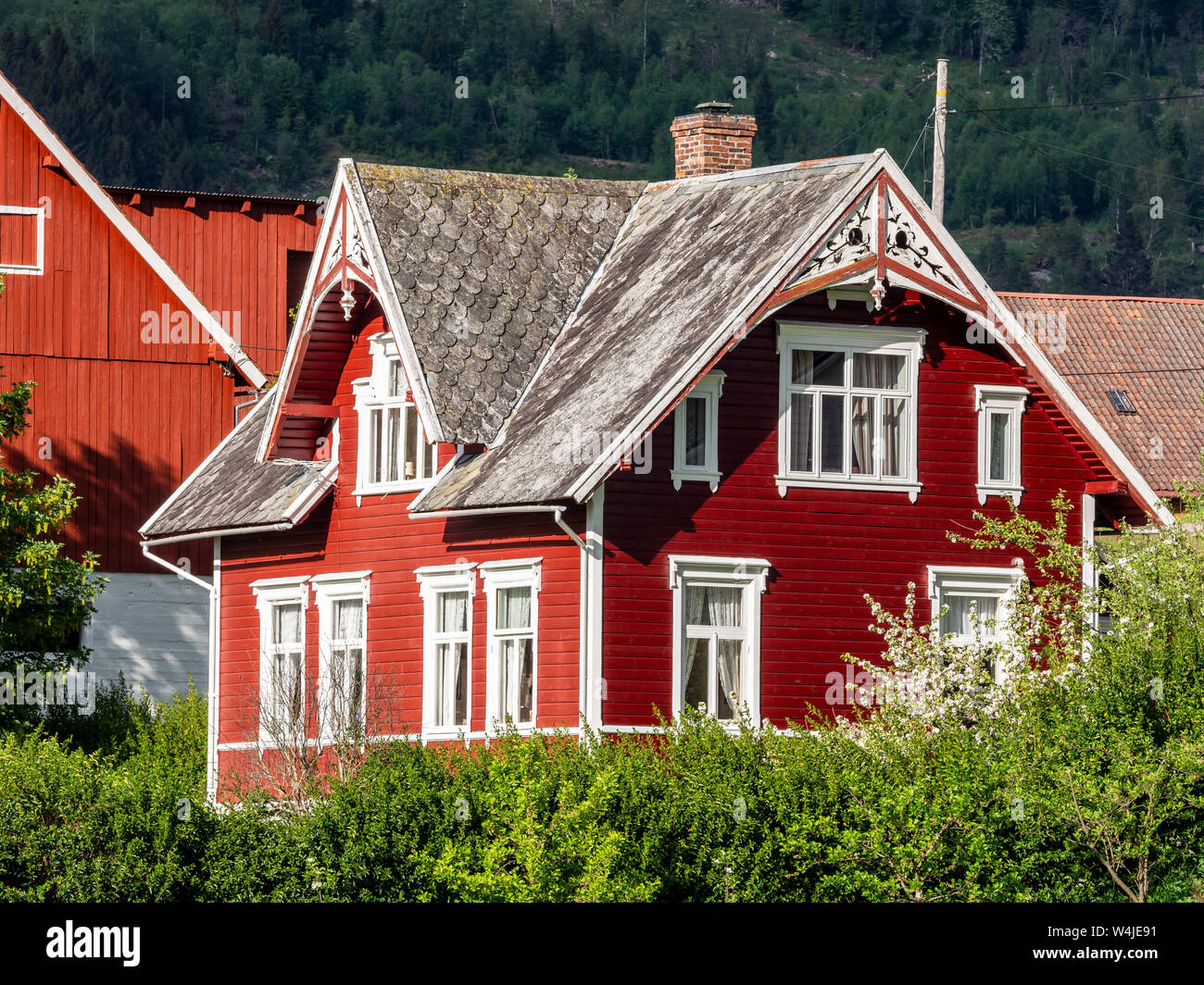 Traditional red wooden house, Nordfjord, white decorations, Norway