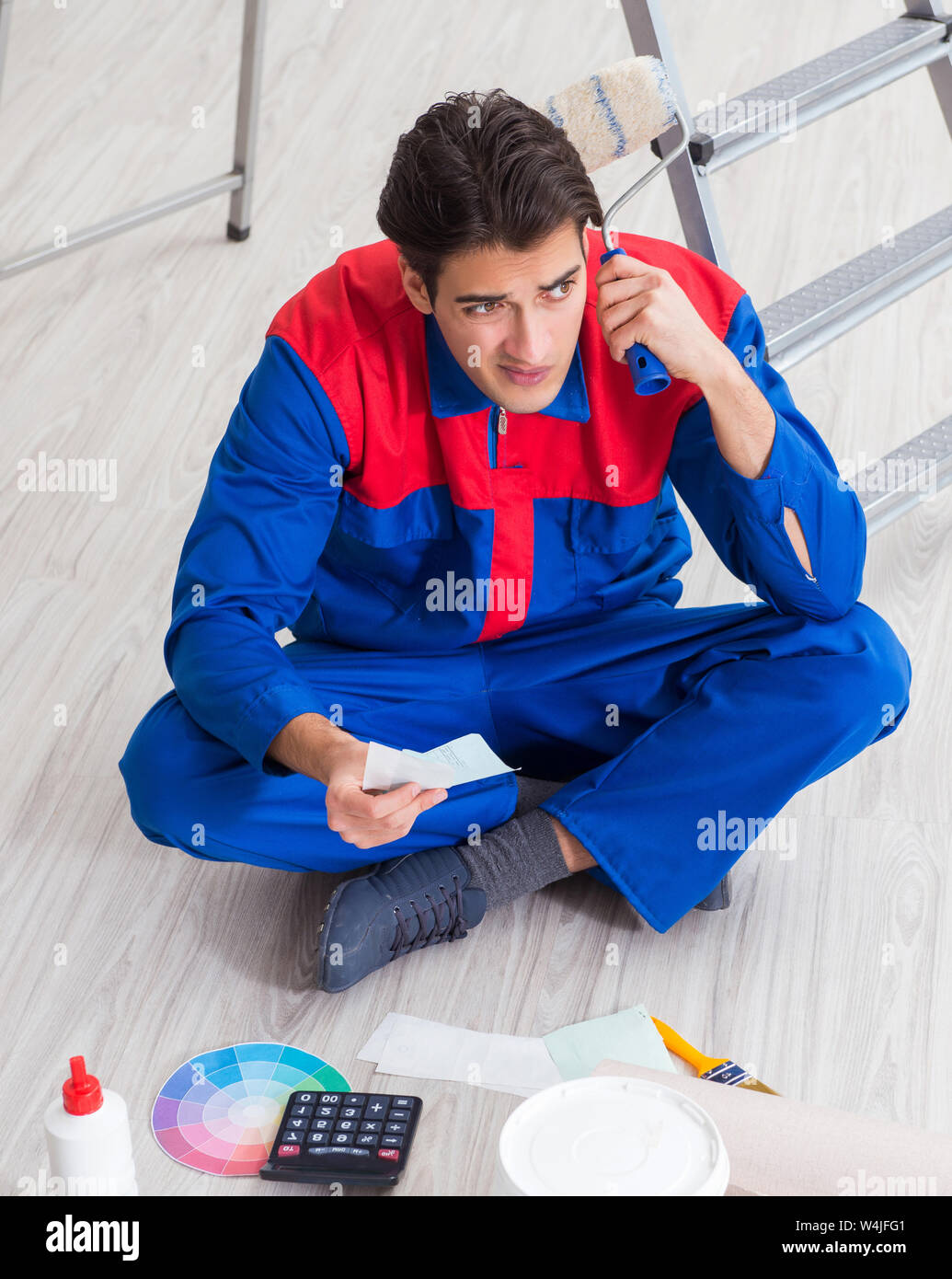 Young painter trying to match colours for painting job Stock Photo Alamy