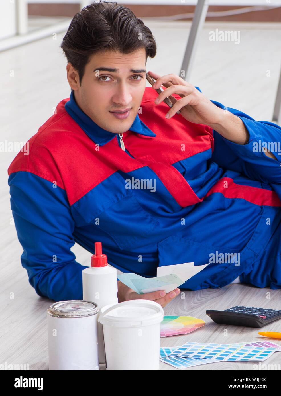 Young painter trying to match colours for painting job Stock Photo Alamy