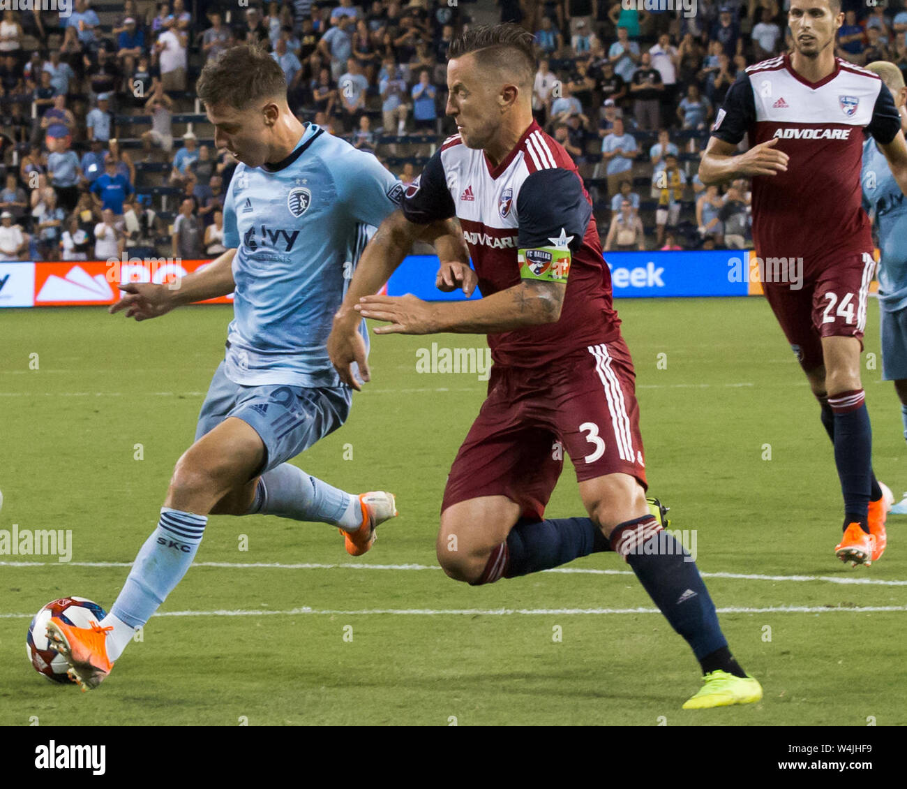 Kansas City, Kansas, USA. 20th July, 2019. Sporting KC forward Krisztian Nemeth #9 (l) drives an attempt on goal against FC Dallas defender Reto Ziegler #3 (r) during the 2nd half of the game. Credit: Serena S.Y. Hsu/ZUMA Wire/Alamy Live News Stock Photo