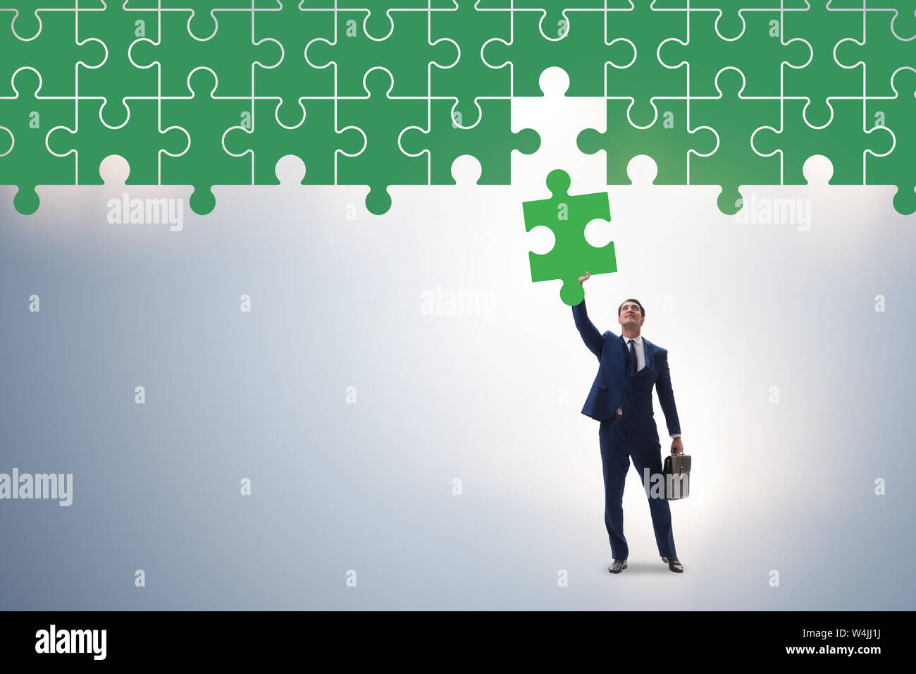 Concept of businessman with missing jigsaw puzzle piece Stock Photo - Alamy