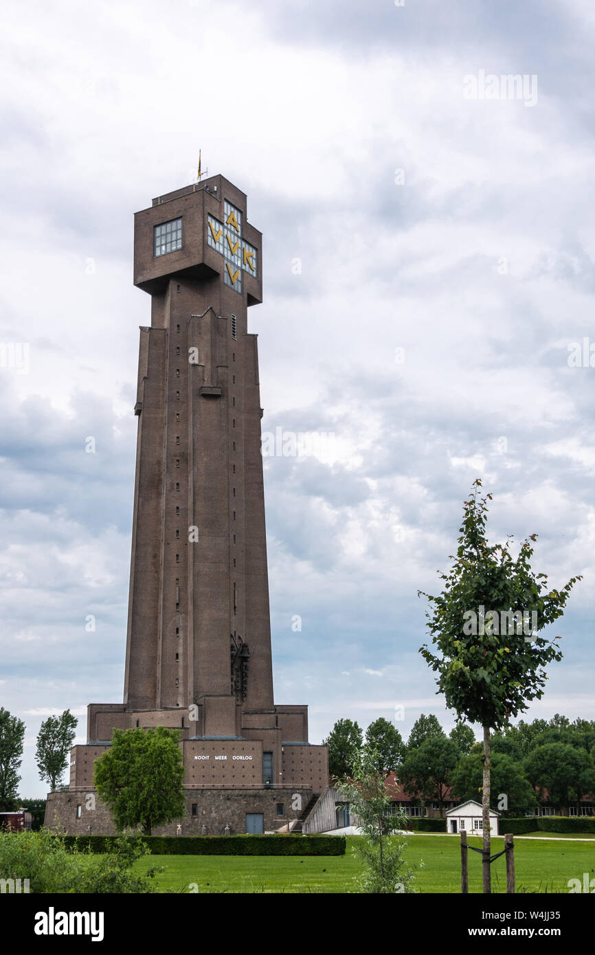 Diksmuide, Flanders, Belgium -  June 19, 2019: IJzertoren, tallest peace monument of WW 1 against gray blue cloudscape. Dutch words saying No More War Stock Photo