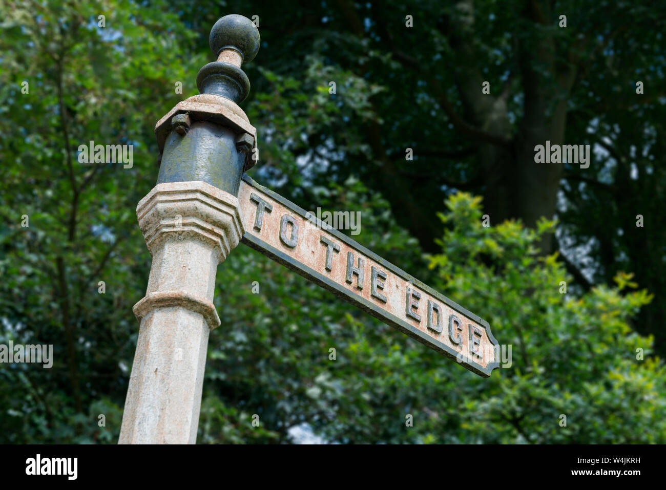 An old fashioned sign indicates 'to the edge' lookout in the small town of Alderley Edge in Cheshire, UK. Stock Photo