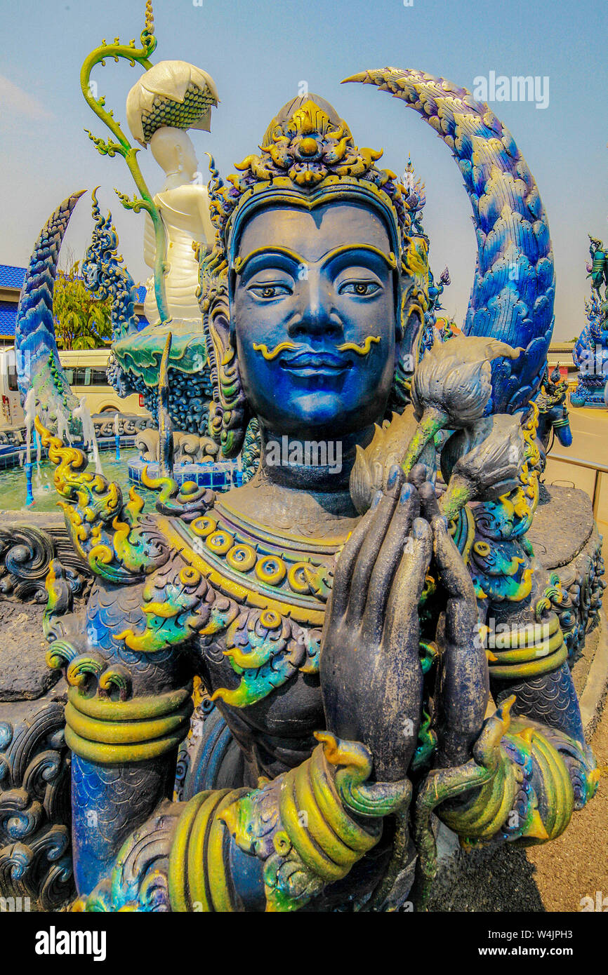 Statue of a blue demon stands near the Blue Temple of Wat Rong Seua Ten near Chiang Rai, Thailand. Stock Photo