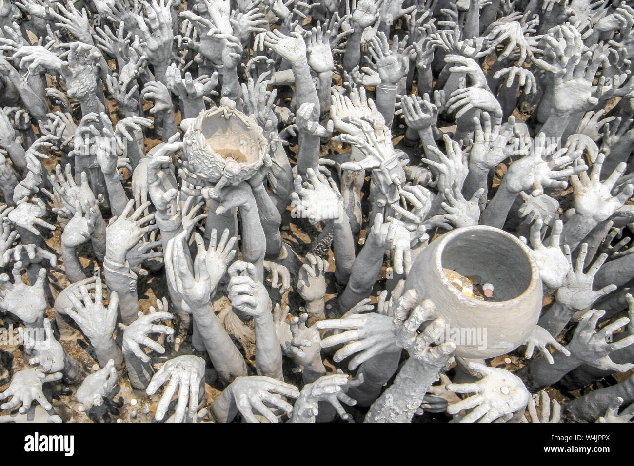 Hundreds of outreaching hands symbolize desire at the Wat Rong Khun, White Timple, at Chiang Rai, Thailand. Stock Photo