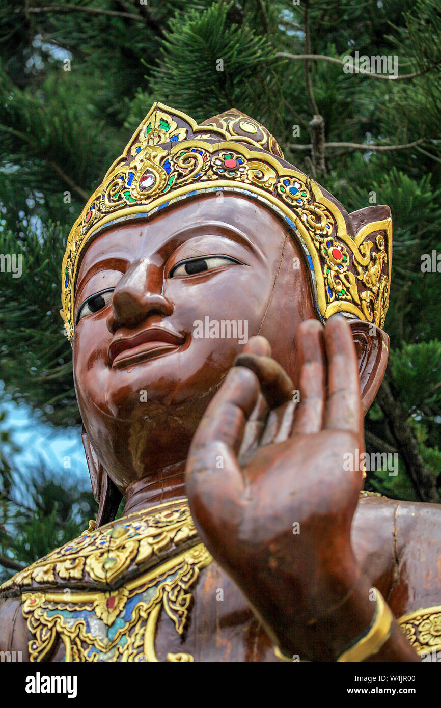 Giant statue of a brown-skin Buddha stands behind  Wat Phra That Doi Suthep near Chiang Mai, Thailand. Stock Photo