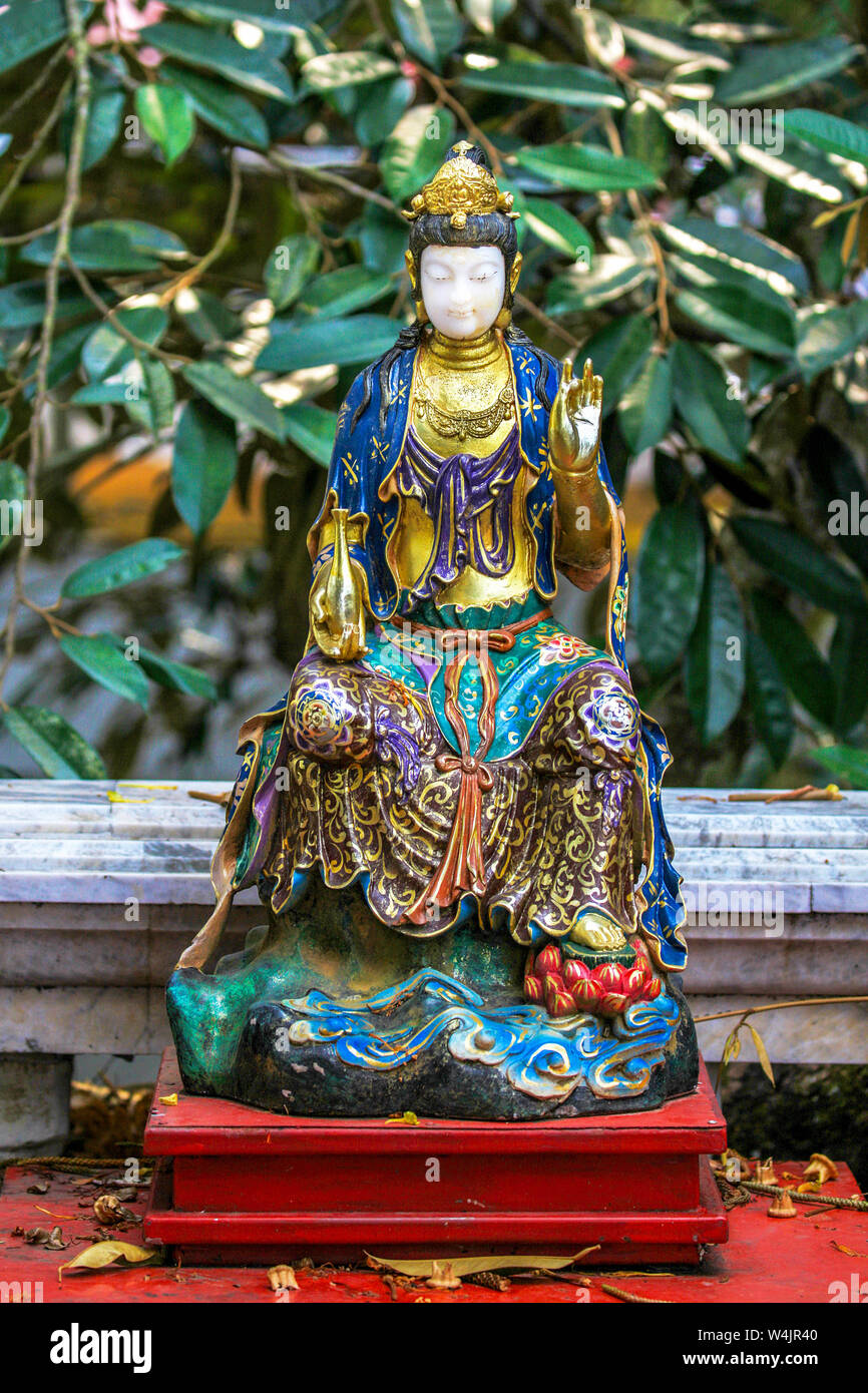 Vintage, small Chinese Buddha statue in a temple Wat near Chiang Mai, Northern Thailand. Stock Photo