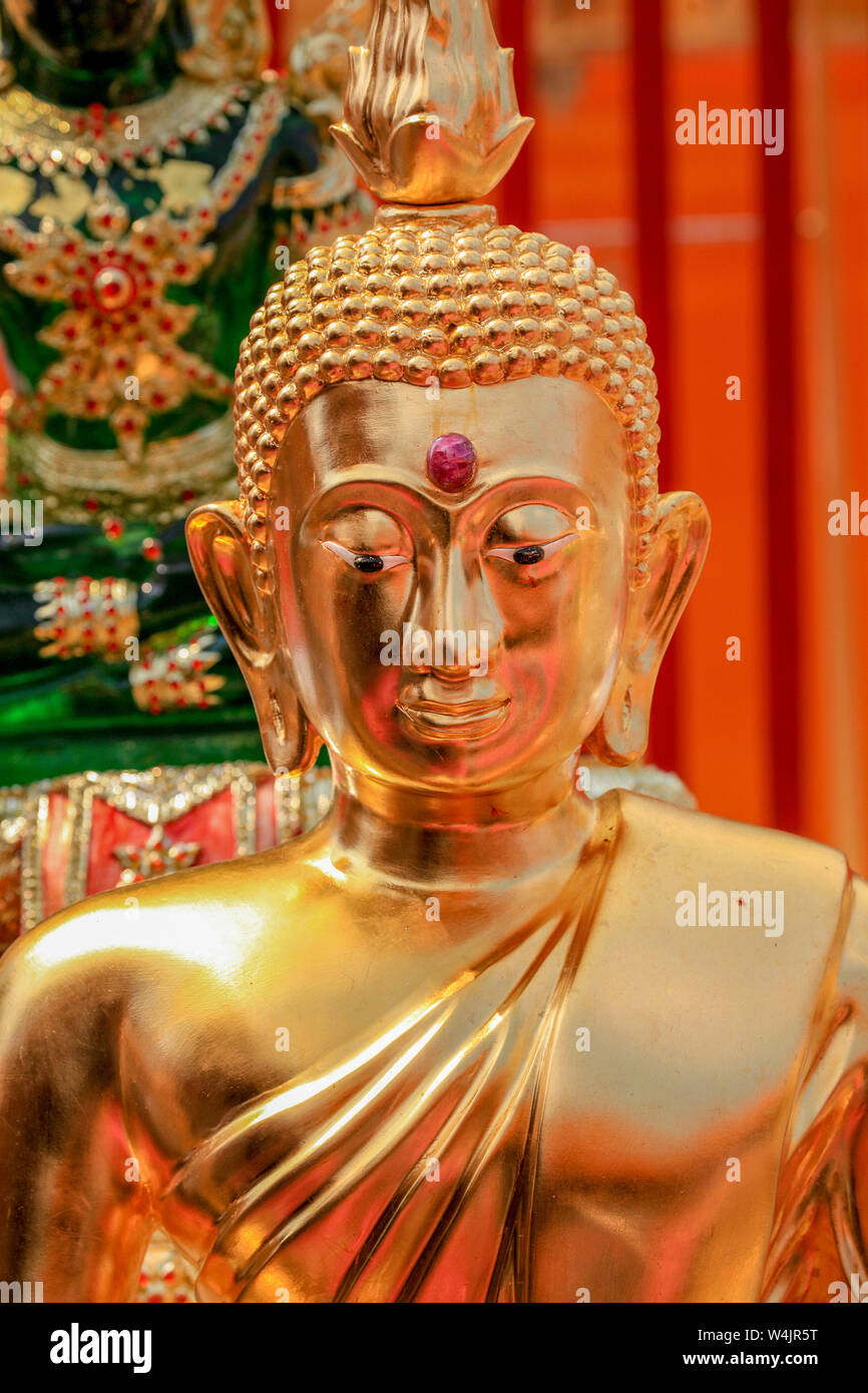 Statue of a seated golden Buddha at the Wat Phra That Doi Suthep temple near Chiang Mai, Northern Thailand. Stock Photo