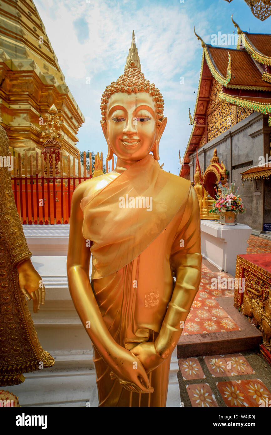 Statue of a smiling, golden Buddha statue at Wat Phra That Doi Suthep ...