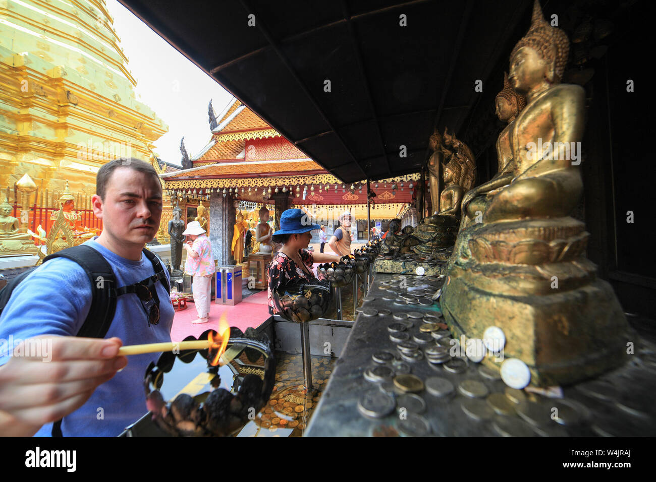 Visitors to the most famous of Thailand's temples, Wat Phra That Doi Suthep, light votive candles to honor Buddha in Chiang Mai, Thailand. Stock Photo