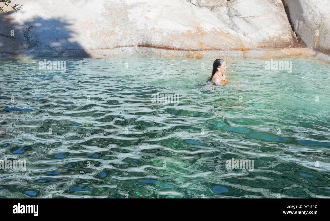 Brunette woman swimming in a mountain river. El Raso, Ávila, Spain Stock Photo
