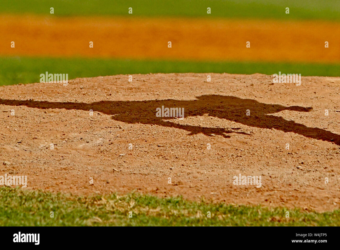 Baseball pitcher's shadow on the mound. Stock Photo
