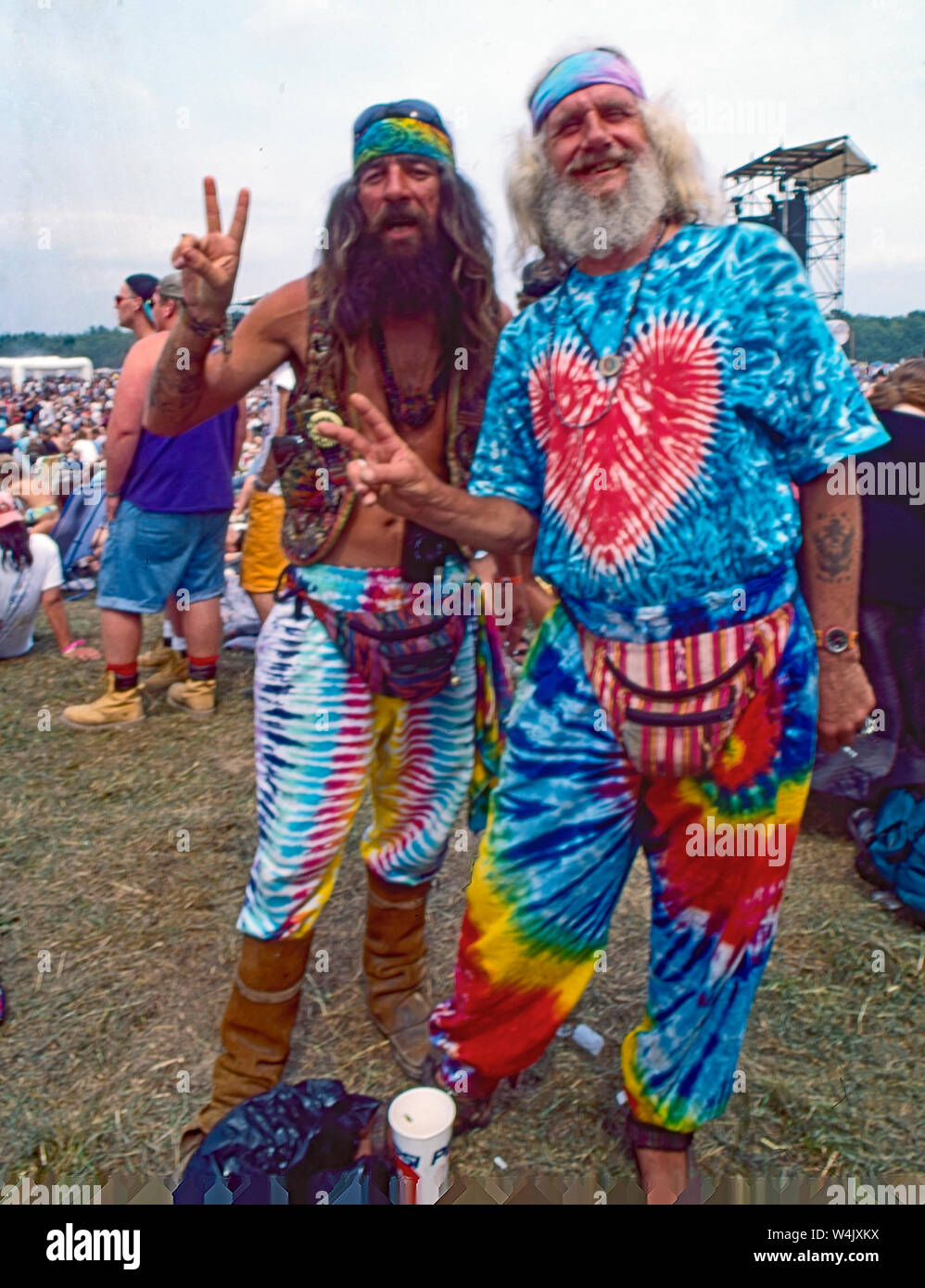 Saugerties, New York, USA, August, 1994 2 old hippies flash the peace sign at Woodstock Ô94