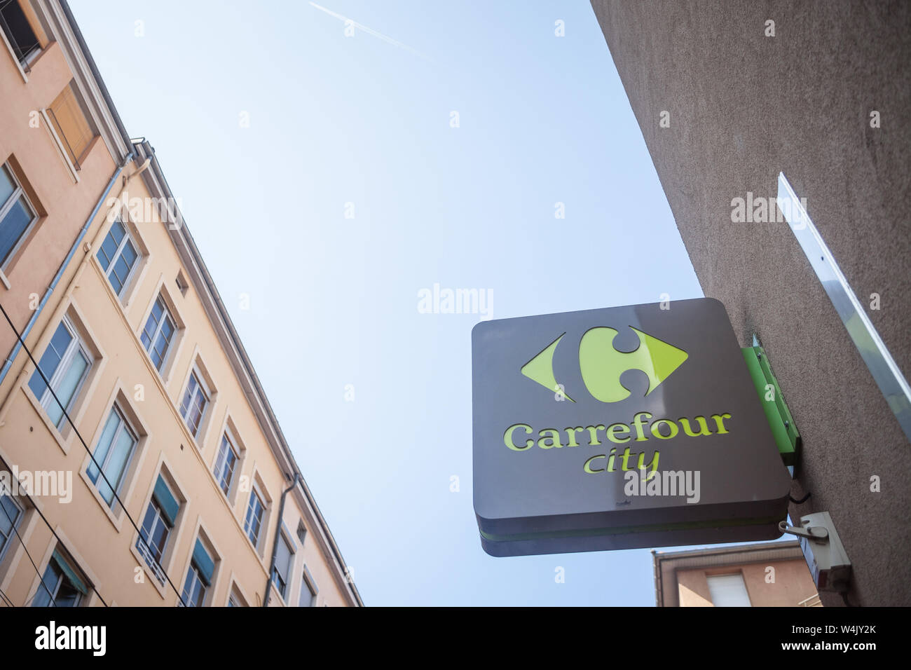 LYON, FRANCE - JULY 17, 2019: Carrefour city logo in front of their local supermarket in downtown Lyon. It belongs to Carrefour Group, one of the main Stock Photo