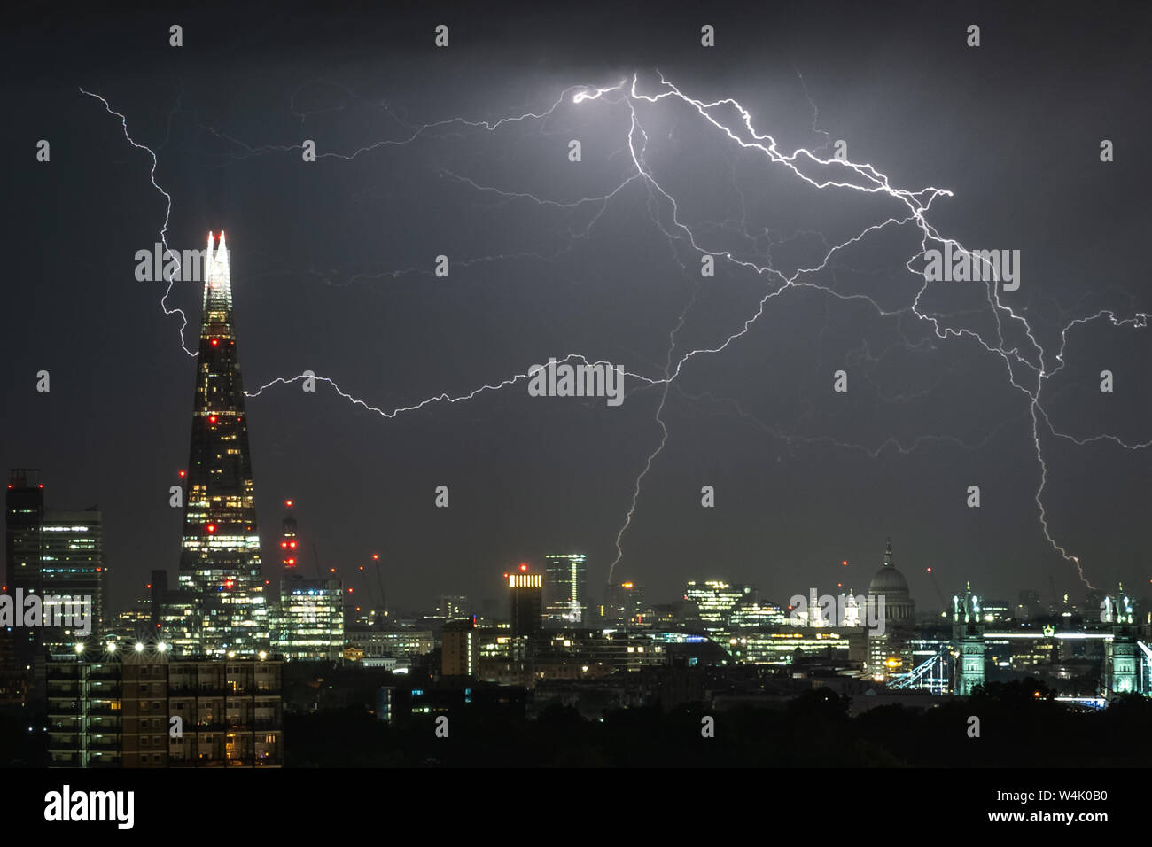 London, UK. 24th July, 2019. UK Weather: Dramatic lightning strikes over the city landscape including The Shard skyscraper building during the early hours. Credit: Guy Corbishley/Alamy Live News Stock Photo