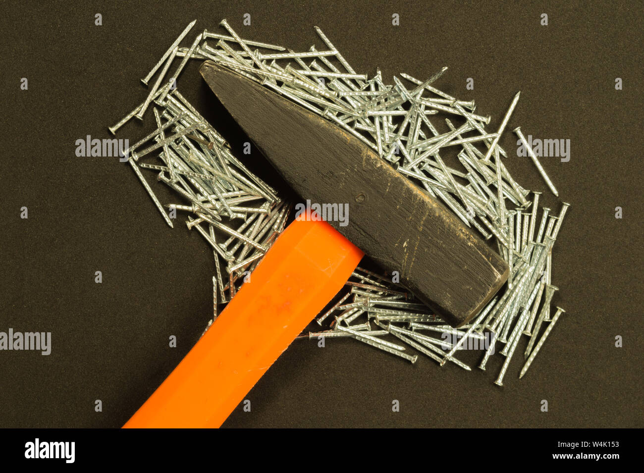 Hammer with metal nails isolated on black background Stock Photo - Alamy