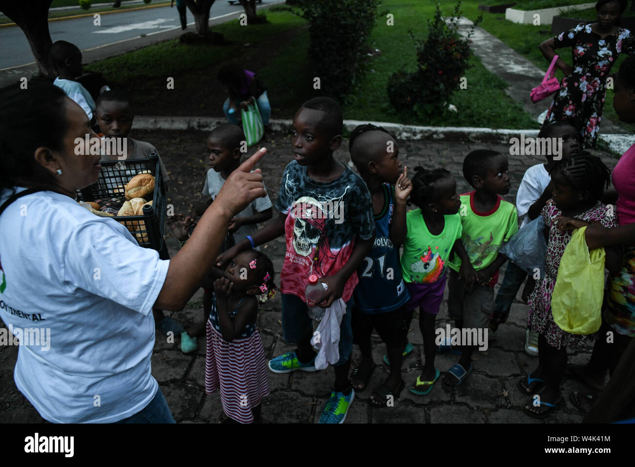 Tapachula, Chiapas, Mexico. 23rd July, 2019. Children from Haitian and African families push to each other on Tuesday, trying to reach a piece of bread and pampers given by catholic nuns of Mision Cristo Resusitado from Guadalajara Mexico, just steps away from Siglo XXI immigration center where most wait three to four months for a permit to travel north to the US-Mexico border. Credit: Miguel Juarez Lugo/ZUMA Wire/Alamy Live News Stock Photo
