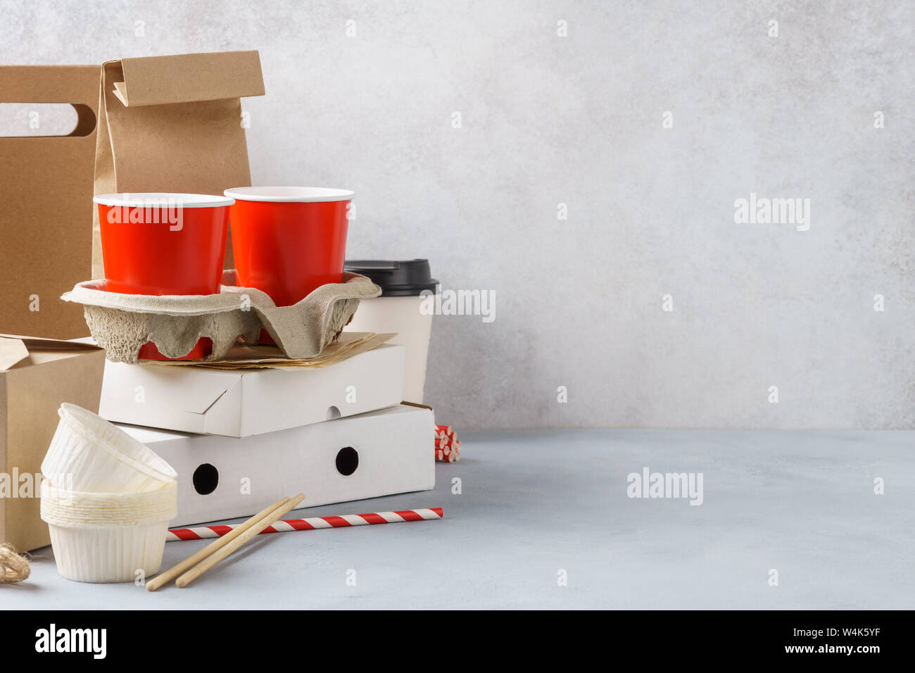 Kraft paper ecofriendly food packaging and tableware on gray