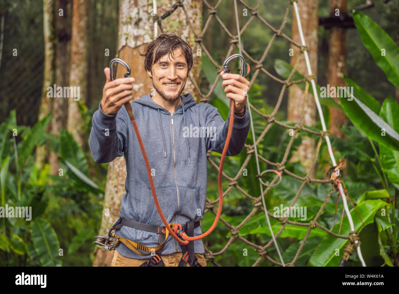 Young men climb rope hi-res stock photography and images - Alamy