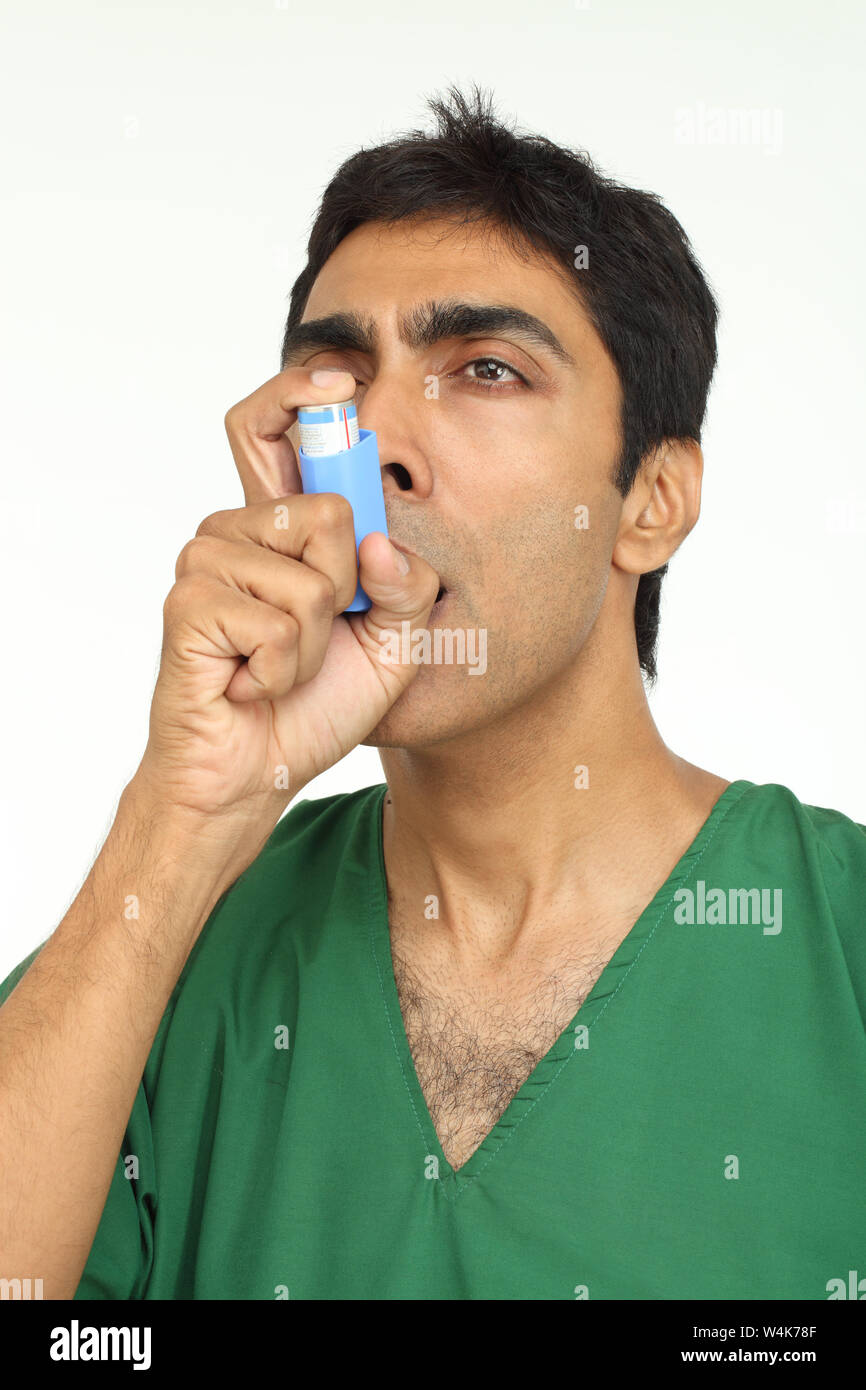 Patient using asthma inhaler Stock Photo