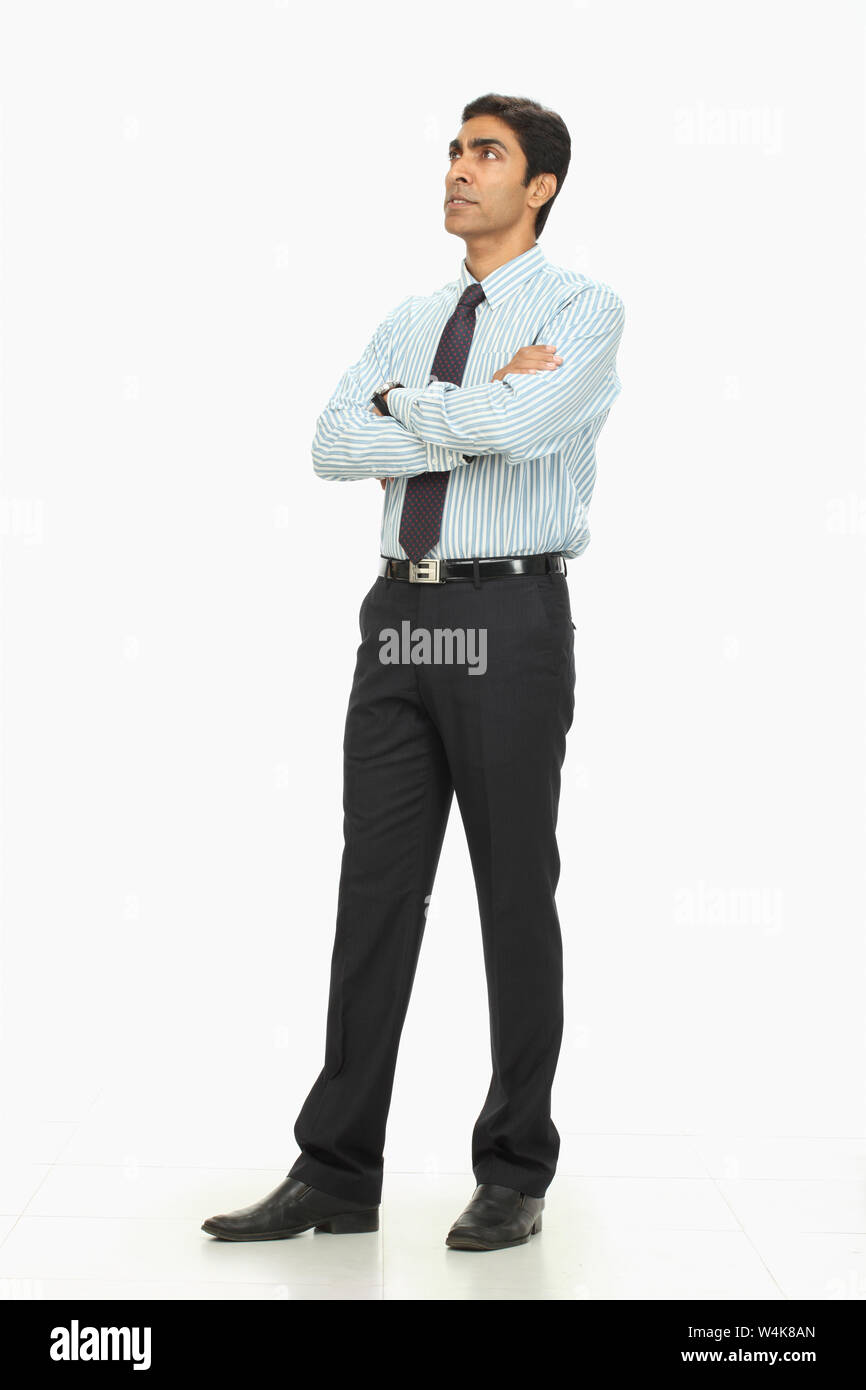 Indian businessman standing with his arms crossed Stock Photo - Alamy
