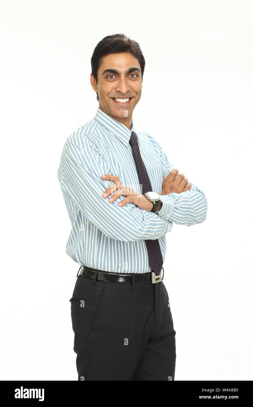 Businessman smiling with his arms crossed Stock Photo - Alamy