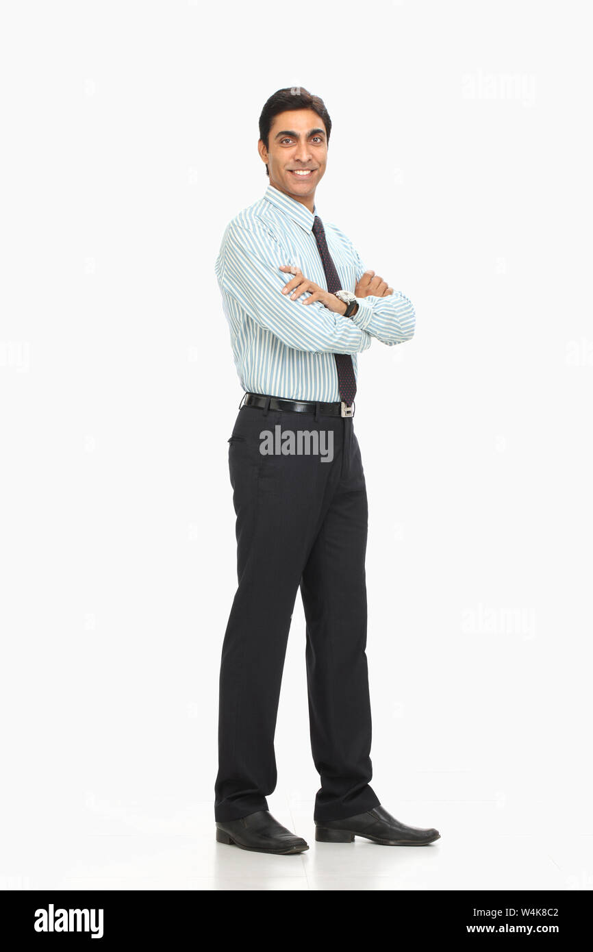 Businessman smiling with his arms crossed Stock Photo - Alamy