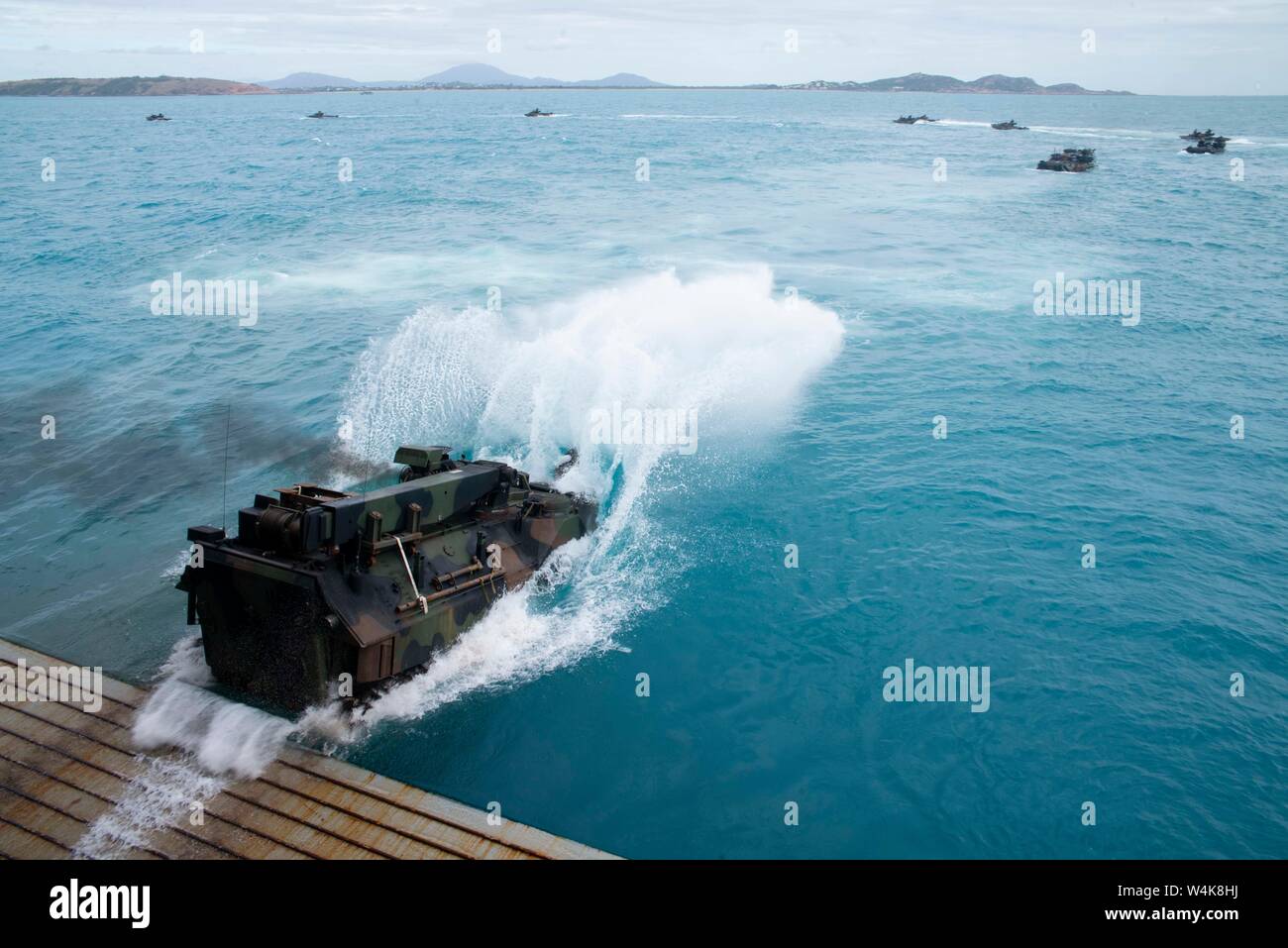 190722-N-DX072-1143 BOWEN, Australia (July 22, 2019) Assault amphibious vehicles (AAV), assigned to the 31st Marine Expeditionary Unit (MEU), depart the well deck of the amphibious transport dock ship USS Green Bay (LPD 20). Green Bay, part of the Wasp Expeditionary Strike Group, with embarked 31st MEU, is currently participating in Talisman Sabre 2019 off the coast of Northern Australia. A bilateral, biennial event, Talisman Sabre is designed to improve U.S. and Australian combat training, readiness and interoperability through realistic, relevant training necessary to maintain regional secur Stock Photo