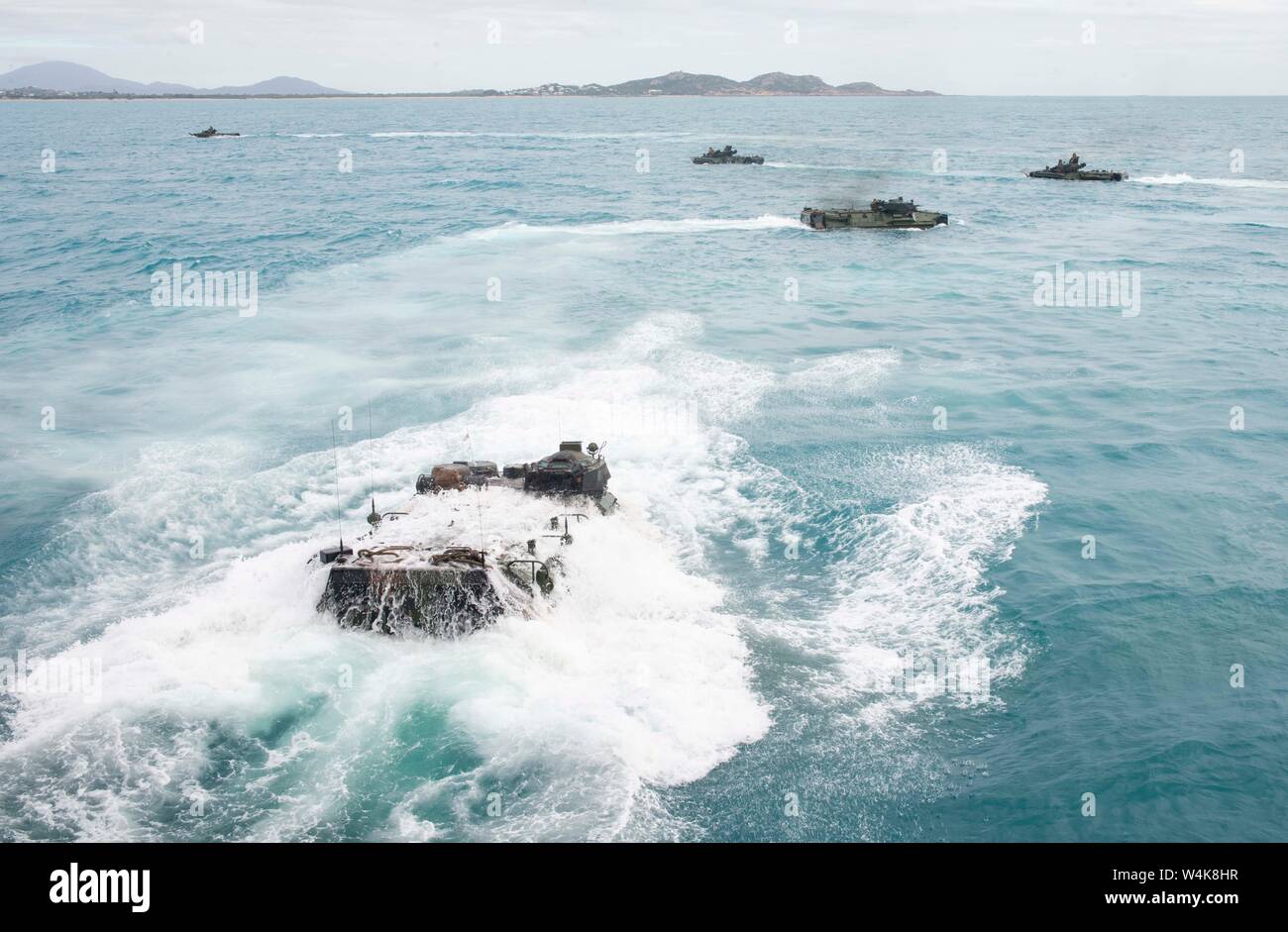 190722-N-DX072-1132 BOWEN, Australia (July 22, 2019) Assault amphibious vehicles (AAV), assigned to the 31st Marine Expeditionary Unit (MEU), depart the well deck of the amphibious transport dock ship USS Green Bay (LPD 20). Green Bay, part of the Wasp Expeditionary Strike Group, with embarked 31st MEU, is currently participating in Talisman Sabre 2019 off the coast of Northern Australia. A bilateral, biennial event, Talisman Sabre is designed to improve U.S. and Australian combat training, readiness and interoperability through realistic, relevant training necessary to maintain regional secur Stock Photo