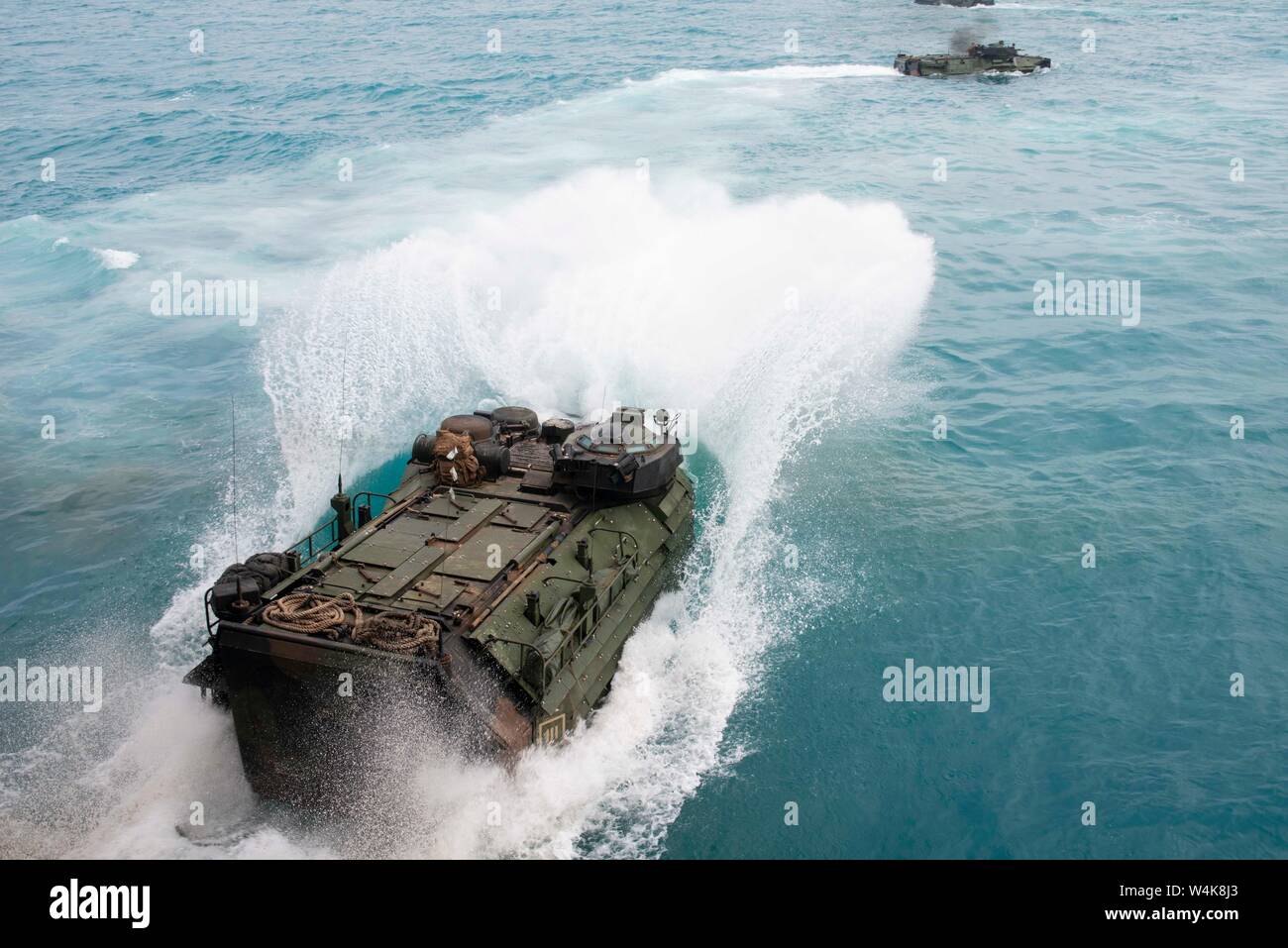 190722-N-DX072-1128 BOWEN, Australia (July 22, 2019) Assault amphibious vehicles (AAV), assigned to the 31st Marine Expeditionary Unit (MEU), depart the well deck of the amphibious transport dock ship USS Green Bay (LPD 20). Green Bay, part of the Wasp Expeditionary Strike Group, with embarked 31st MEU, is currently participating in Talisman Sabre 2019 off the coast of Northern Australia. A bilateral, biennial event, Talisman Sabre is designed to improve U.S. and Australian combat training, readiness and interoperability through realistic, relevant training necessary to maintain regional secur Stock Photo
