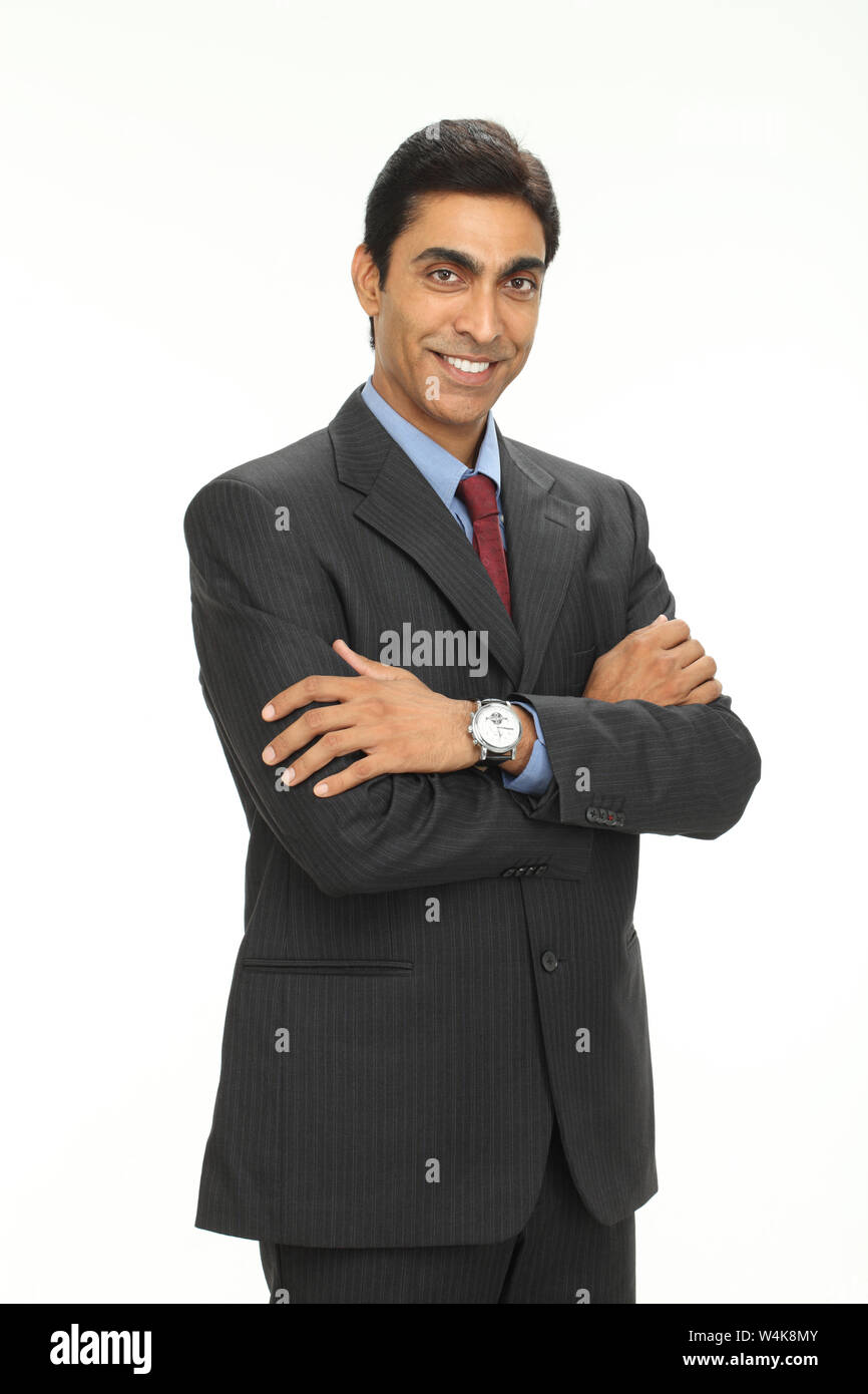 Businessman smiling with his arms crossed Stock Photo - Alamy
