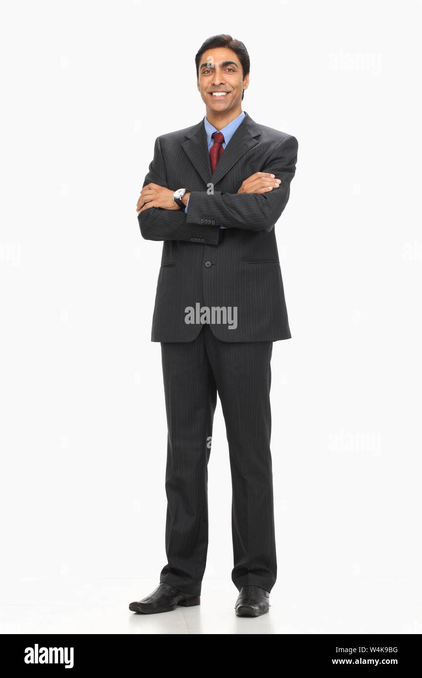 Businessman smiling with his arms crossed Stock Photo - Alamy