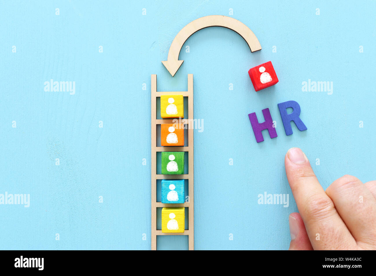 Business image of wooden ladder with people icons over blue table ...