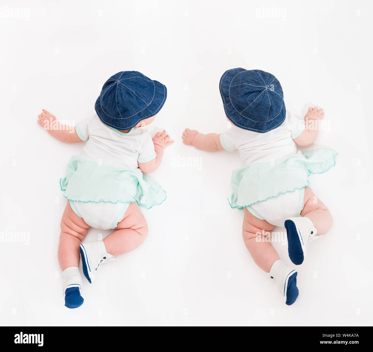 Crawling Baby on white Background in jeans hat and bootees, Infant Kid
