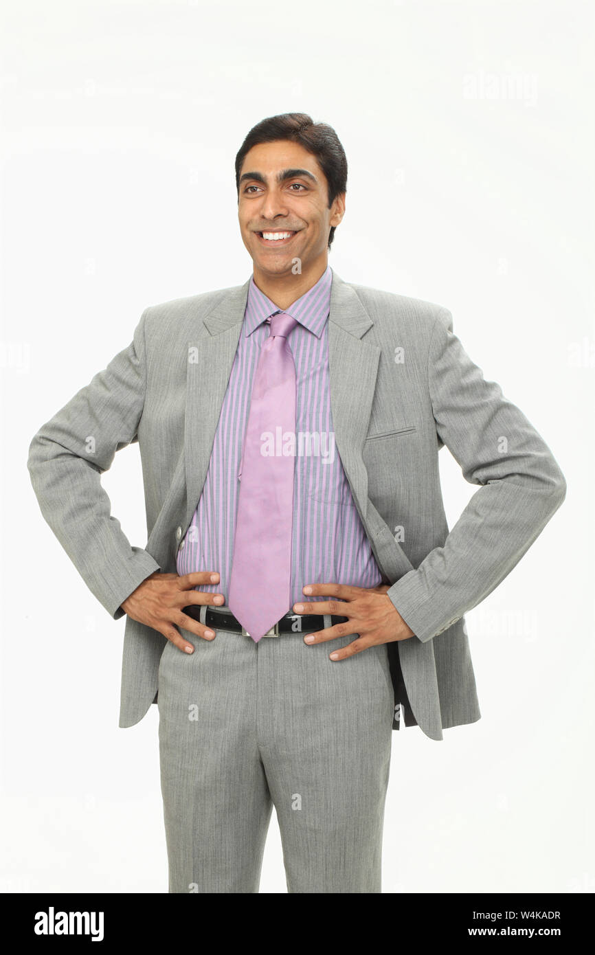 Businessman standing with his arms akimbo Stock Photo - Alamy