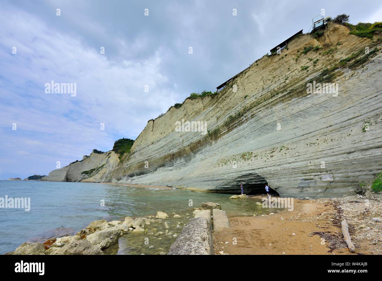 Tourists inside a cave on Loggas Beach,peroulades ,Corfu,Greece,Ionian Islands Stock Photo