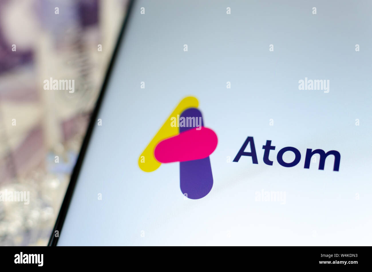 Atom bank app on the smartphone screen. Close up photo. Stock Photo