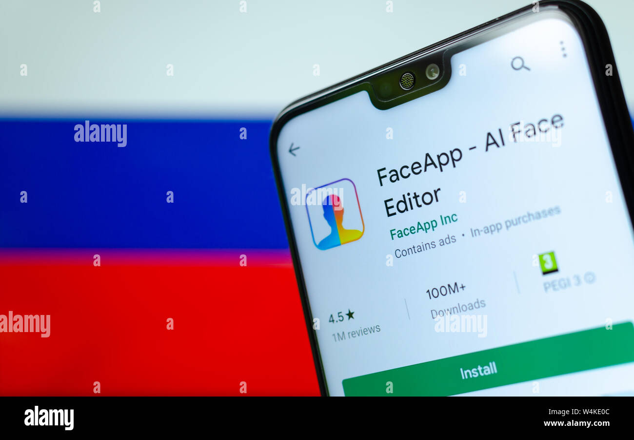 FaceApp logo on the screen of smartphone with the flag of Russia at the ...