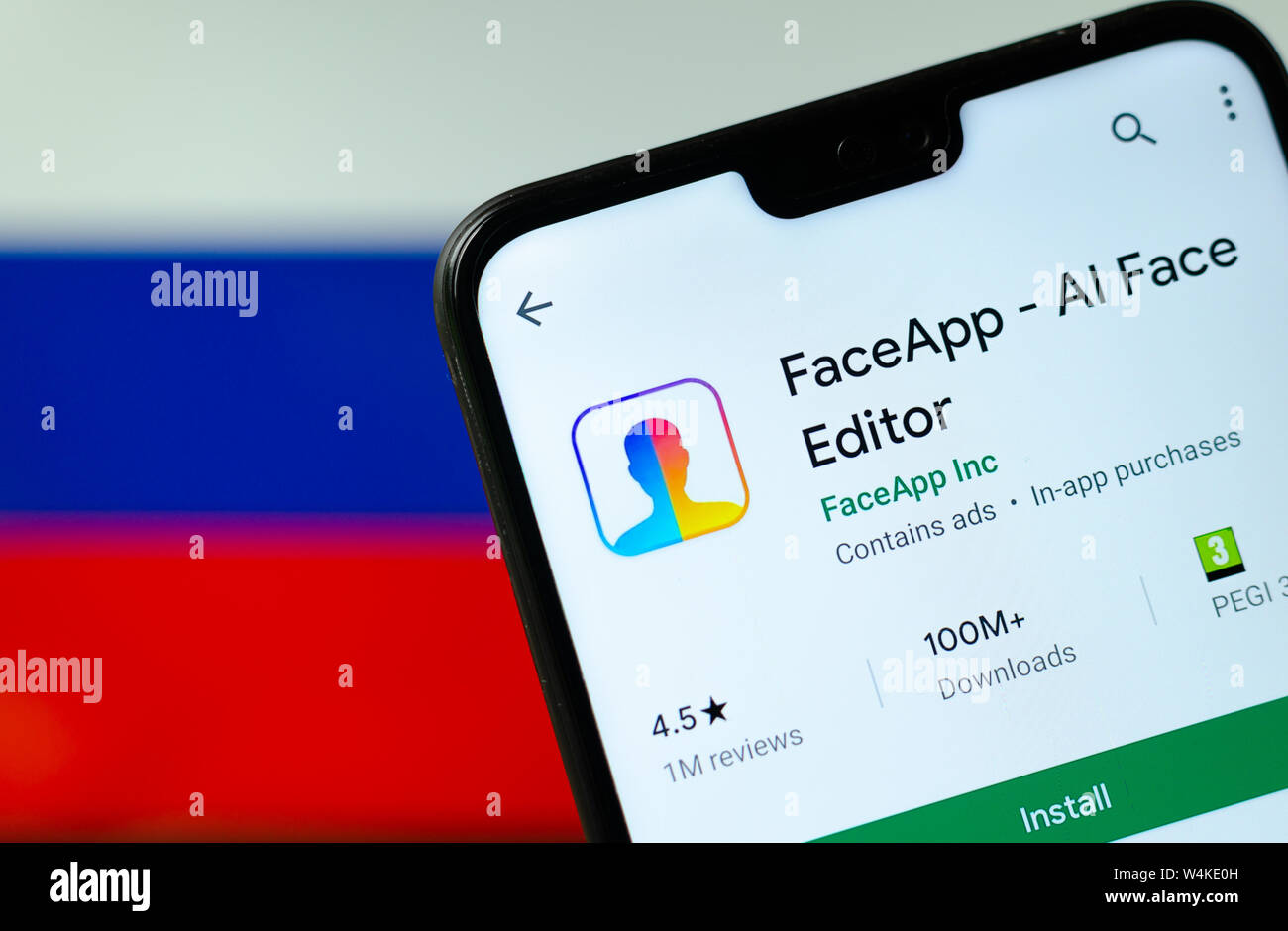 FaceApp logo on the screen of smartphone with the flag of Russia at the ...