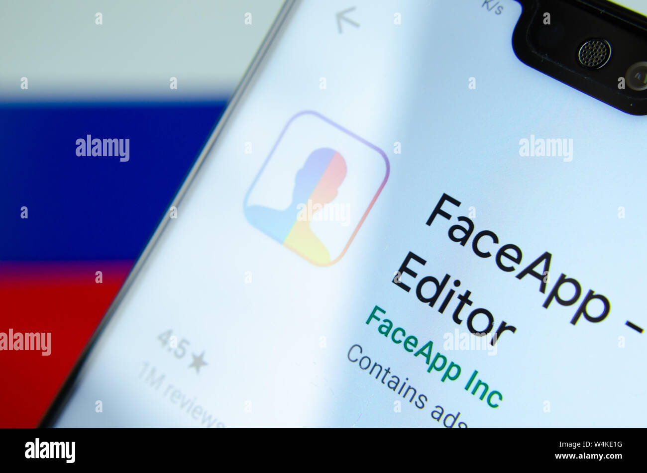 FaceApp logo on the screen of smartphone with the flag of Russia at the ...