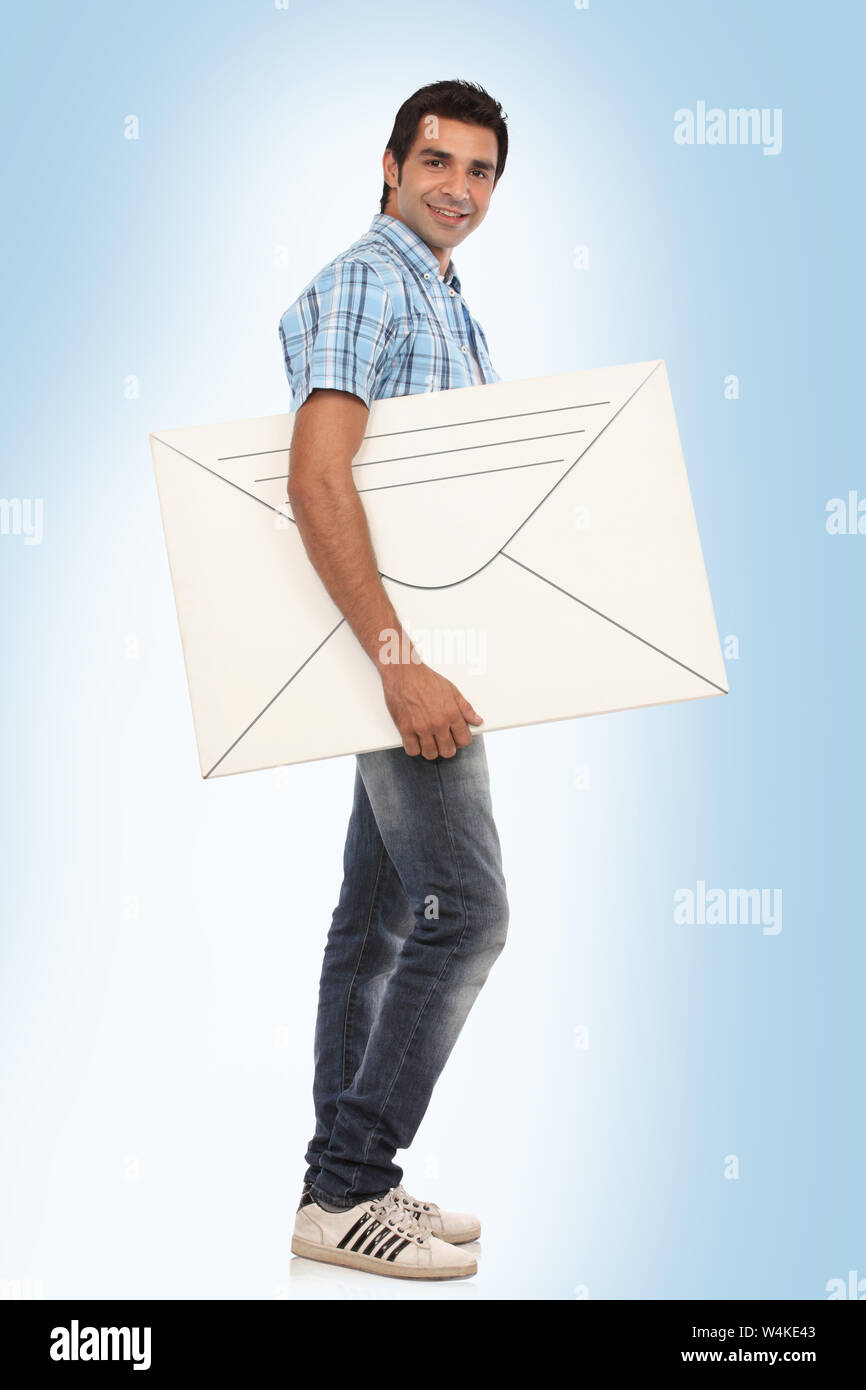 Man with big envelope in hand Stock Photo Alamy