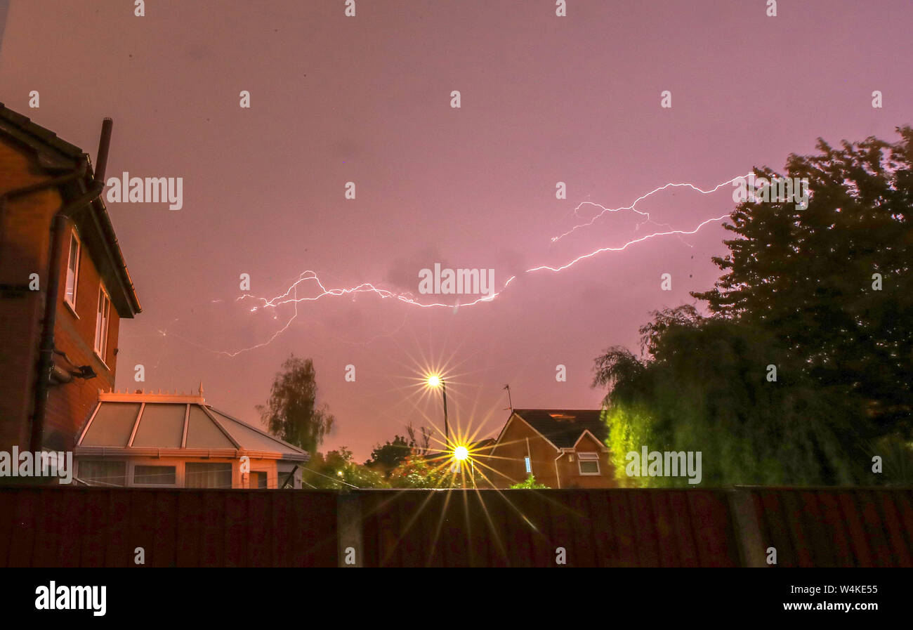 Lightning strikes as a thunder storm passes over houses in Lee Park, Liverpool, Merseyside. The UK is expected to edge towards its hottest ever July day, with the mercury due to soar above 30C (86F). Stock Photo