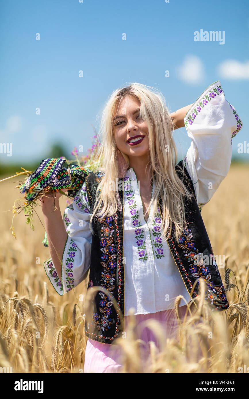 Beautiful girl in traditional costume in a wheat field Stock Photo - Alamy