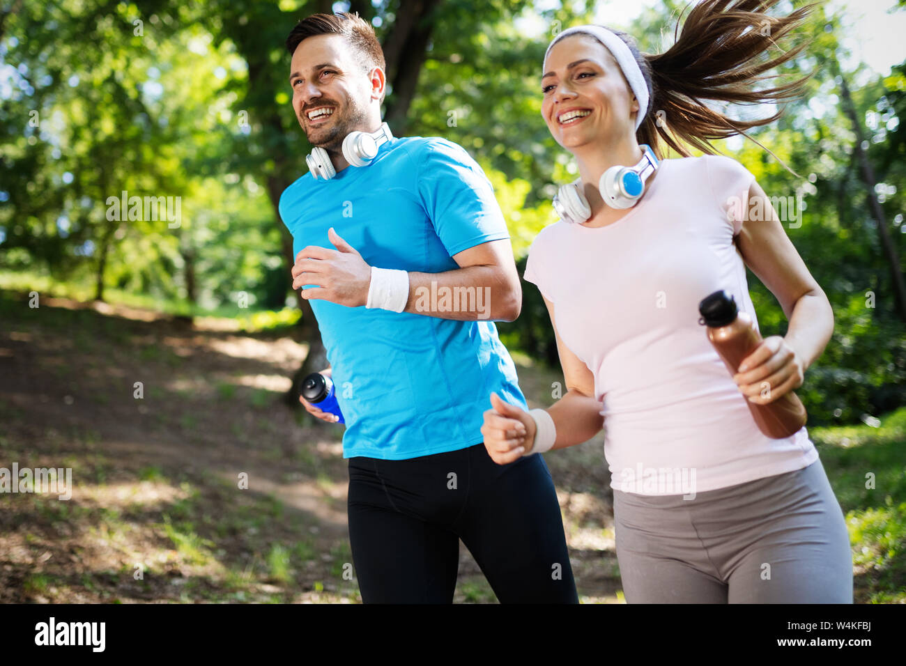 Happy couple running and exercising together outdoor Stock Photo - Alamy