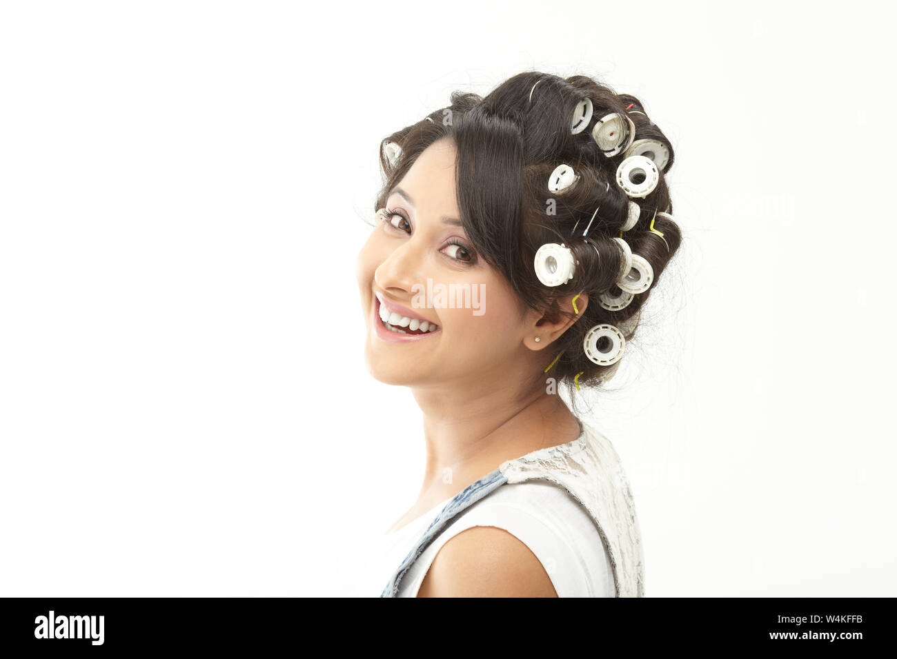 Indian woman smiling with rollers in hair Stock Photo Alamy