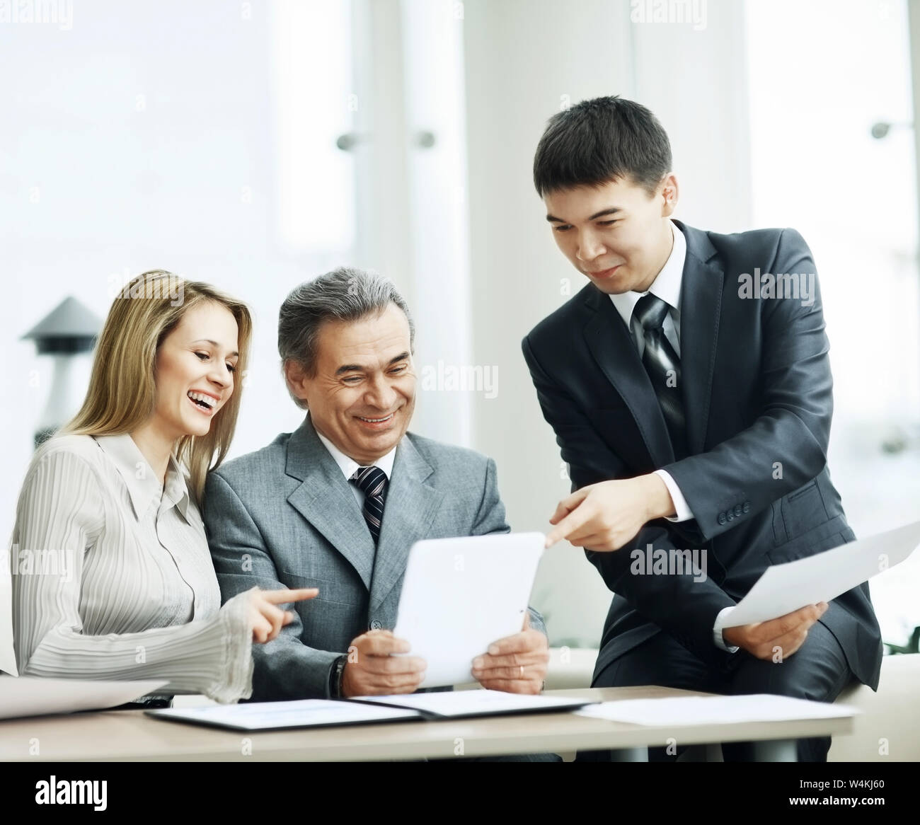 A successful business group discusses a work plan using in the tablet Stock Photo