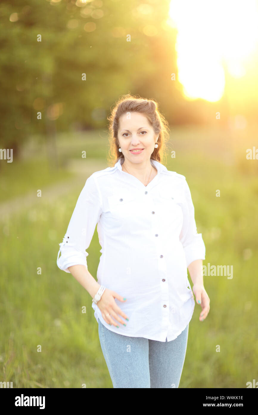 beautiful pregnant woman on a walk in the Park on a Sunny day Stock ...