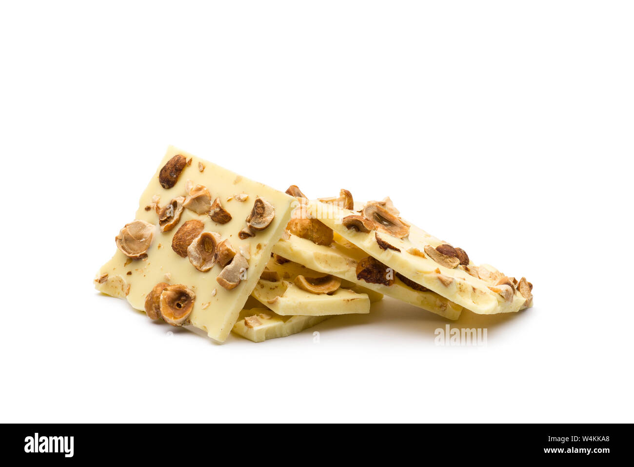hazelnut white chocolate chunks on white background Stock Photo
