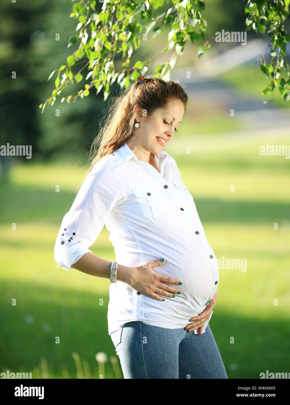 beautiful pregnant woman on a walk in the Park on a summer day Stock ...