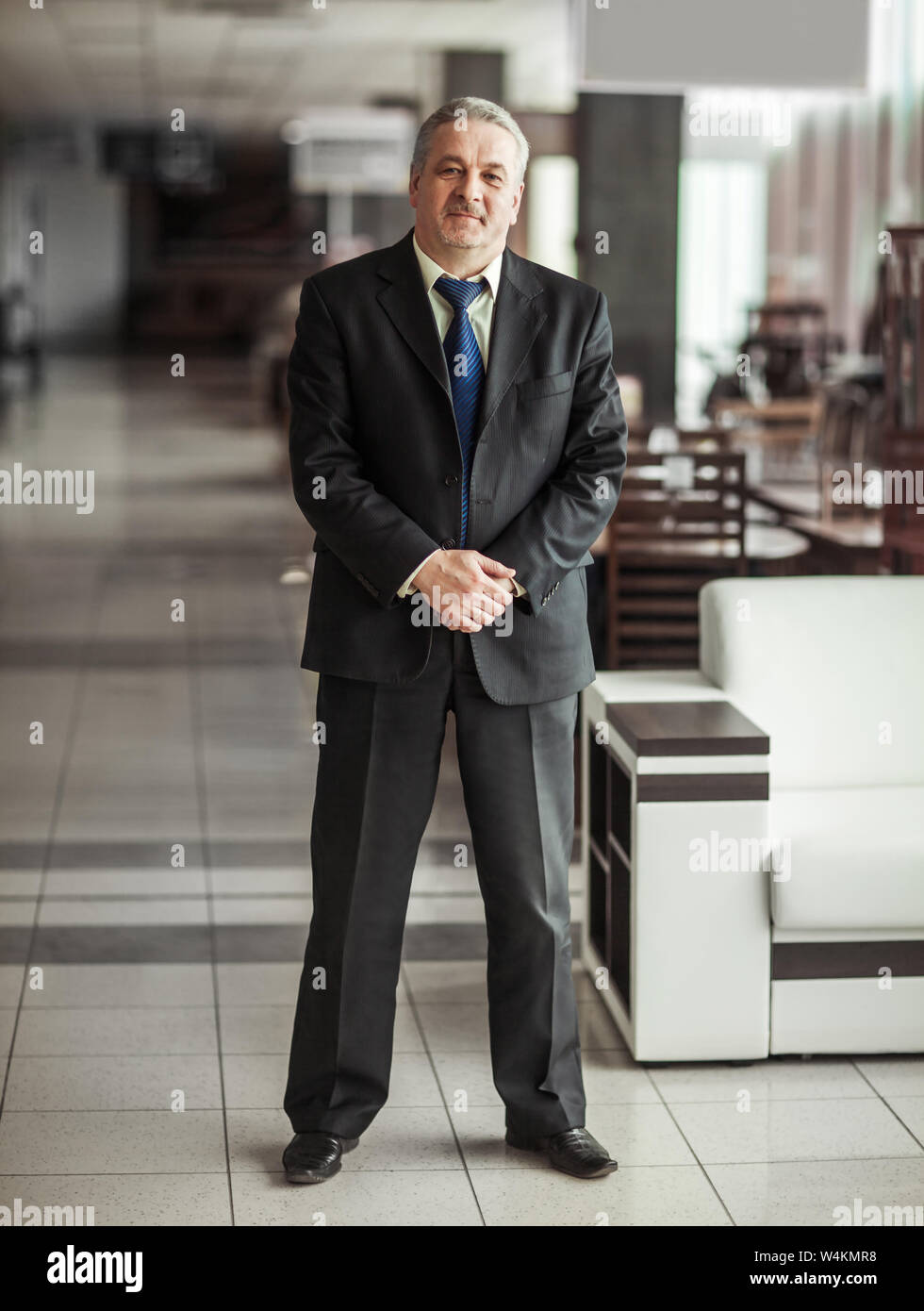 successful businessman in a business suit on background of modern office Stock Photo